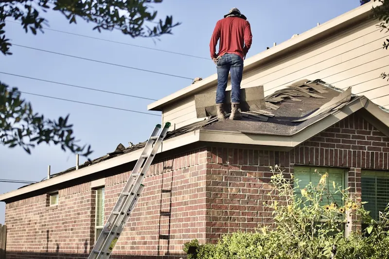 Professional roofer working on a residential roof in Leeward Park